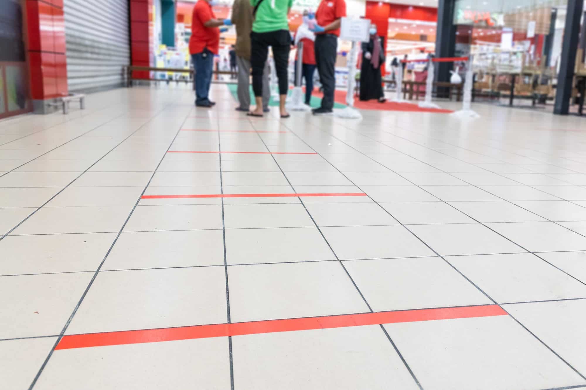 New normal lifestyle with social distancing in queue into supermarket.