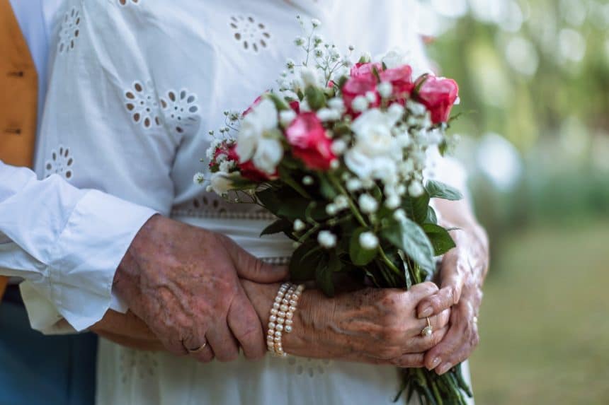 Close-up of seniors hands with wedding rings during their marriage.