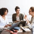Group of cheerful young women studying together