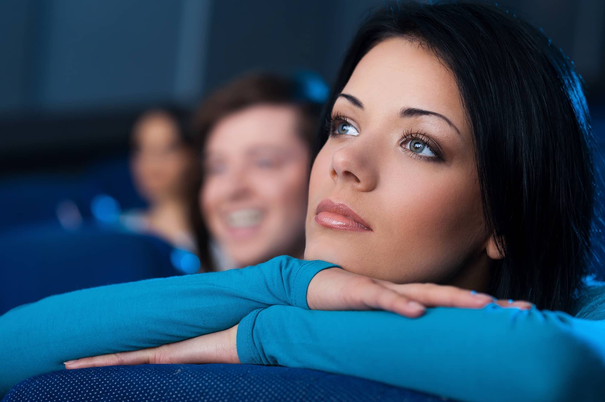 Woman at the cinema. Beautiful young woman watching movie at the cinema