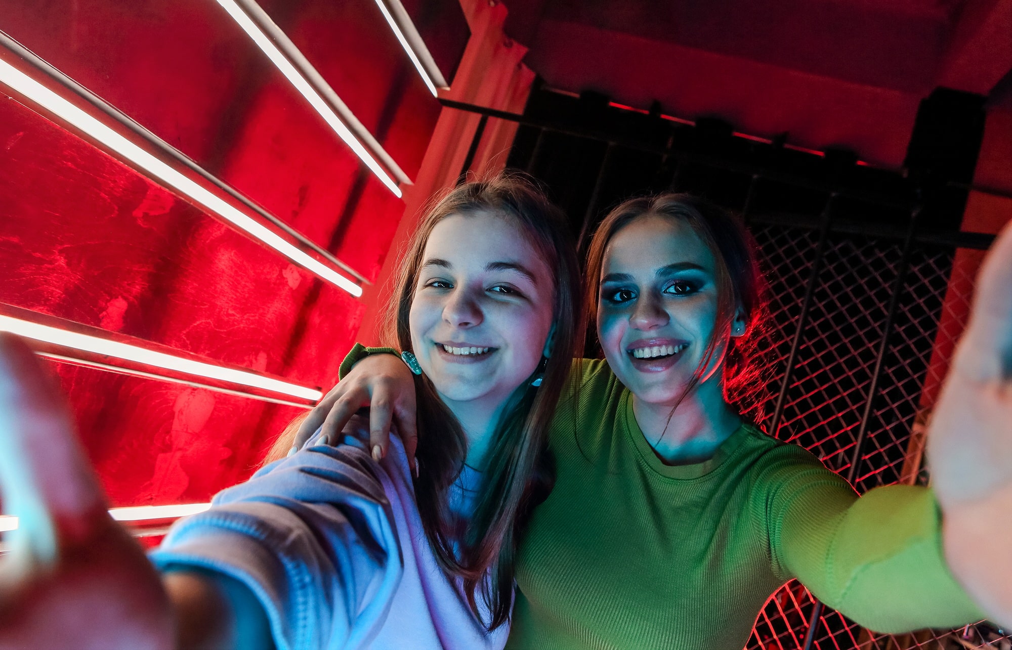 Two happy best female friends young girls at disco party posing for photo