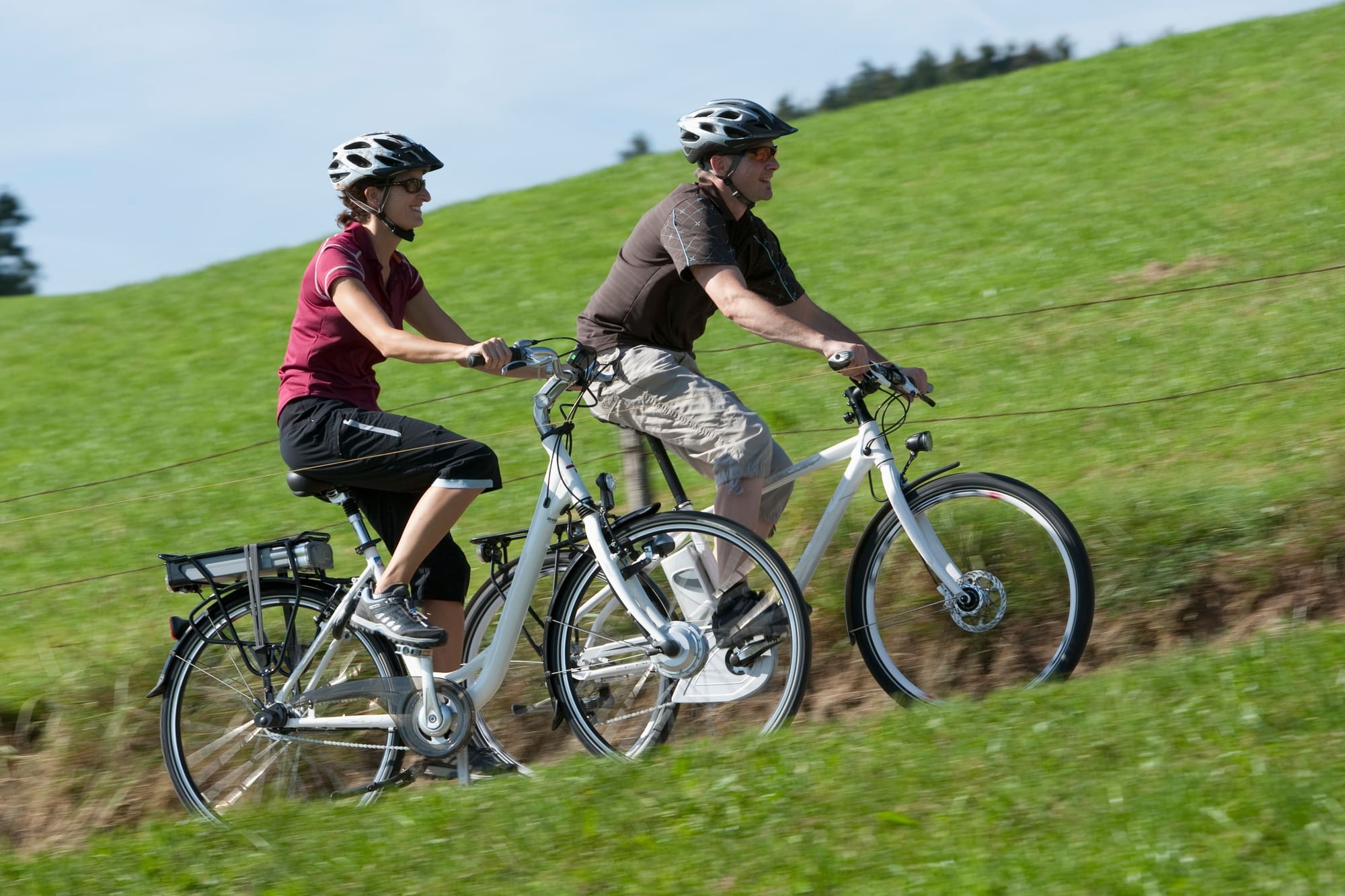 Germany, Bavaria, Man and woman riding electric bicycle