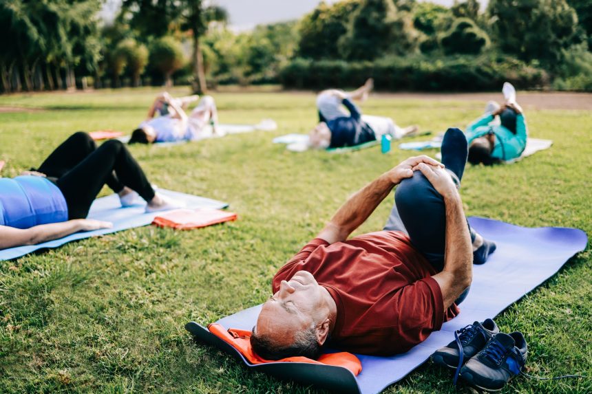 Senior sport people exercising during yoga class outdoor at park city - Elderly healthy lifestyle
